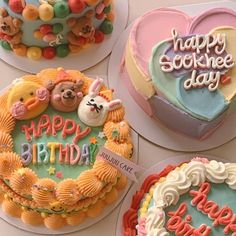 four decorated birthday cakes sitting on top of a table