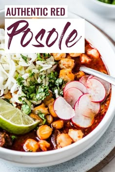 a white bowl filled with soup and garnished with sliced radishes, limes, shredded parmesan cheese, cilantro, and other vegetables