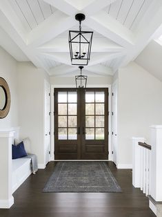 an image of a house with white walls and wood floors, the door is open