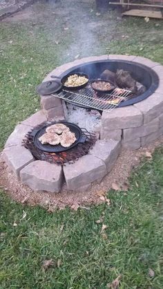 an outdoor fire pit with grills and food cooking on it