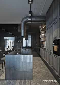 an industrial kitchen with stainless steel counter tops and cabinets, along with open shelving