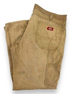 *PLEASE READ ENITRE DESCRIPTION AND REFER TO MEASUREMENTS BEFORE PURCHASING* Vintage Dickies Canvas Workwear Carpenter Pants Size 38 Beige MEASUREMENTS Size is based off our measurements, not the tagged size. Please refer to measurements. SIZE - 38 WAIST FLAT - 19" (measurement is multiplied by 2 to get the size) RISE - 12" INSEAM - 30" LEG OPENING -9 " Please note that due to the nature of pre-owned clothing; the size mentioned in the title may not be an accurate representation of the item's fi Vintage Beige Bottoms With Pockets, Vintage Khaki Work Pants, Vintage Work Pants With Patch Pockets, Vintage Workwear Pants With Buttons, Vintage Khaki Trousers, Vintage Dickies, Vintage Trousers, Carpenter Pants, Mens Trousers