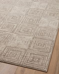 an area rug on the floor with wooden floors