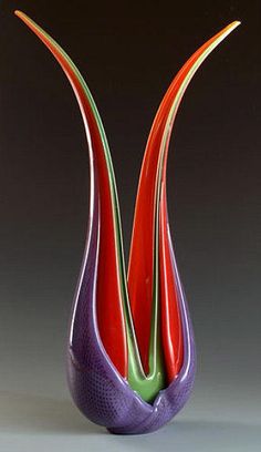 three different colored vases sitting on top of each other