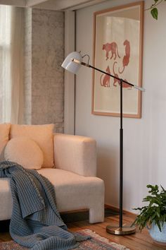 a living room with a couch, lamp and rug