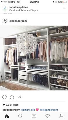 an organized closet with clothes, shoes and chandelier hanging from it's ceiling