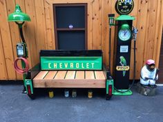 a bench sitting next to two gas pumps