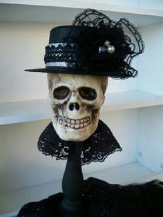 a skull wearing a hat with black lace on it