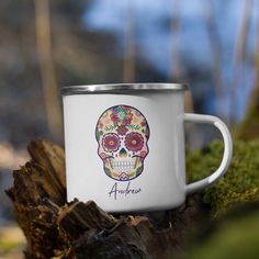 a white coffee mug with a colorful sugar skull on the side and name alpenon