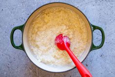 a red spoon in a pot filled with rice