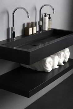 two black sinks with white towels on them