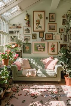 a living room filled with lots of potted plants and pictures on the wall above it