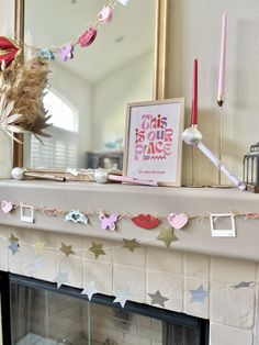 a decorated mantle with candles and decorations on it in front of a mirror above a fire place