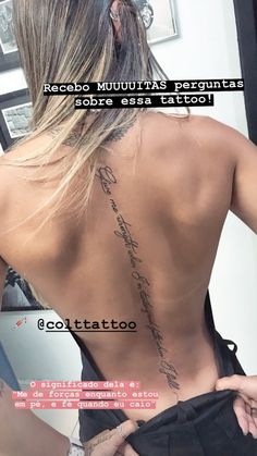 the back of a woman's body with writing on her upper and lower back