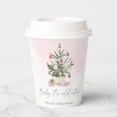 a coffee cup with a christmas tree on the front and baby it's all right inside