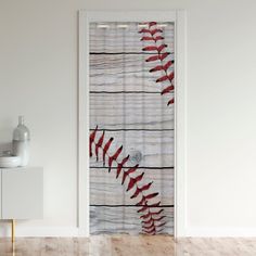 a baseball themed shower curtain hangs on the wall next to a white cabinet and mirror