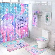 a bathroom with mermaid themed rugs and shower curtain