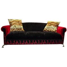 a black and red couch with leopard print pillows