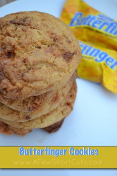 a stack of cookies sitting on top of a white plate next to a bag of chips