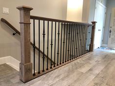 a wooden banister with black iron handrails in a home's entryway