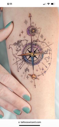 a woman's arm with a compass tattoo on the left side of her body