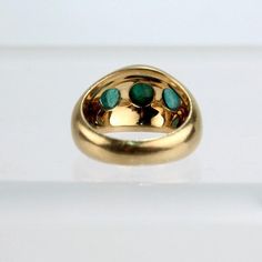 A very fine Gubelin 18k gold emerald cabochon ring.  With three smooth oval emerald cabochons bezel set in a regal, signet style 18k gold thick band ring.  A wonderful ring from one of the worlds finest jewelers!  Date: 20th Century  Overall Condition: It is in overall good, as-pictured, used estate condition  Condition Details: There is some very light roughness surface scratches to the tops of the emeralds, and other signs of expected light wear consistent with age.  Fineness: Marked 750 for 1 Thick Band Ring, Gold And Emerald, Emerald Cabochon, Worlds Finest, Cabochon Ring, Fine Jewels, Three Stone Rings, Three Stone, Bezel Setting