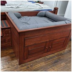 a wooden bed frame with mattress and drawers