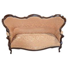 an old fashioned couch with ornate carvings on it's back and armrests