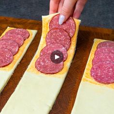 someone is making some kind of appetizer with salami and cheese on it