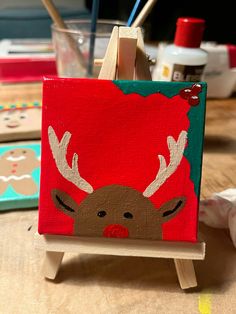 an easel with a reindeer painted on it