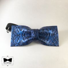 "The bow tie polymer clay is a fashion accessory. Its absolute impact is unique in the world. Wearing it will give you an original and elegant touch to each outfit (formal and informal). It is a perfect gift idea because it hilights the affection you feel for your beloved. Completely handmade, its composition and its structure make it ideal for anyone and especially for who is approaching the world of bow ties because it is a pre-tied type. The bowtie is mounted on an adjustable elastic with hook and eye closure: this makes it very comfortable. All bowties are completely handmade so sizes are approximate and may vary slightly. Approximate sizes: 11.0 cm x 5 cm (4.4\"x2.0\") The strap is adjustable up to 45 cm (18 \"). That listing is inspiring by arabesque and classic brocade, adding a tou Blue Bow Tie With Butterfly Knot For Formal Events, Blue Tie With Decorative Bow For Parties, Blue Party Tie With Decorative Bow, Elegant Blue Adjustable Bow Tie, Blue Bow Tie As A Gift, Adjustable Blue Bow For Formal Occasions, Blue Dapper Suit And Tie Accessories For Party, Blue Tie With Bow Tie Back As A Gift, Blue Satin Bow Tie For Black-tie Events