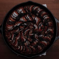 a pan filled with food on top of a wooden table