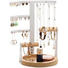 a jewelry rack with several different types of necklaces and rings hanging from it's sides