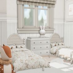 two beds in a room with white walls and wooden floors, one has a stuffed animal on top of the bed