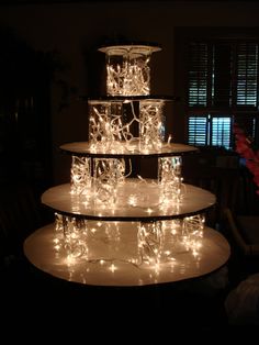 three tiered cake with lights on it