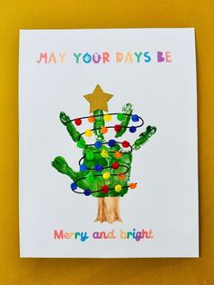 a christmas card with a handprinted cactus holding a star and the words may your days be merry and bright