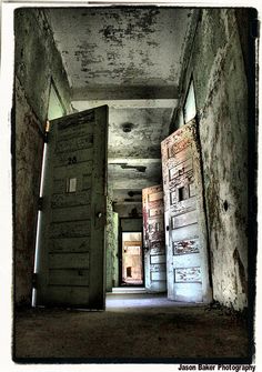 an old hallway with two doors open