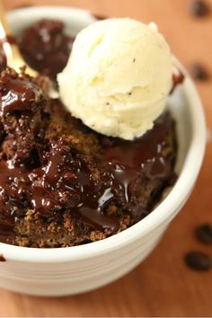 a close up of a bowl of food with ice cream and chocolate cake in it