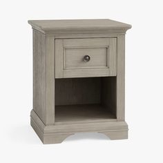 the small nightstand is made from wood and has an open drawer on one side,