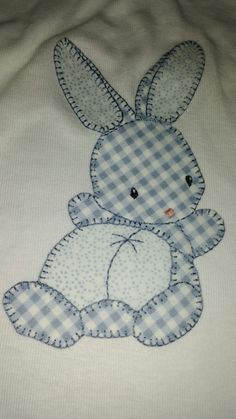 a blue and white checkered bunny on a white shirt with gingham fabric