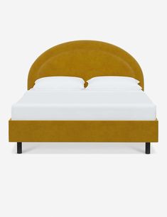 an upholstered bed with white sheets and yellow headboard, viewed from the front