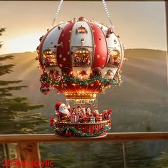 a large red and white hot air balloon with santa clause on it's side