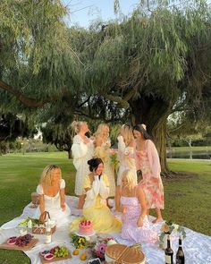 a group of women sitting around a picnic table