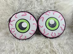 two pink and green eyeballs on white fur