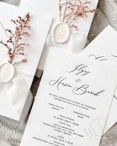 the wedding stationery is laid out on top of each other