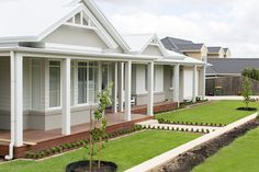 a row of houses with lawns and landscaping