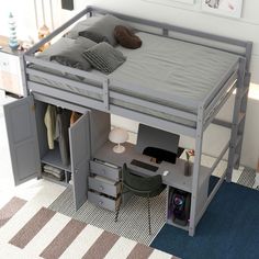 a loft bed with a desk underneath it