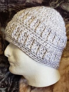 a white knitted hat on top of a mannequin's head,