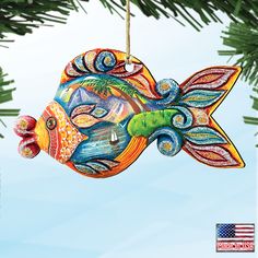 a colorful fish ornament hanging from a tree