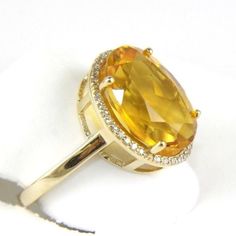 This Is A Fancy Sparkling Oval Honey Yellow Citrine Ring W/Diamond Halo. It Is Made Of 100% Natural 14kt Yellow Gold And Is In Brand New Condition. It Has A Ctw Of 5.44ct (0.14 Diamond/5.30 Citrine) And Weighs 4.4 Grams. The Fancy Diamonds Have A Clarity Of Si1 And H Color. This Beautiful Custom Piece Has An Excellent Oval Cut Yellow Citrine Stone, Surrounded By A Diamond Halo. This Ring Is The Latest In Fashion Design Having Unique Designer Qualities That Is Full Of Shine And Clarity. Pukhraj Ring, Stone Ring Design, Delicate Fine Jewelry, Yellow Citrine Ring, November Birthstone Jewelry, Honey Yellow, Beautiful Gold Necklaces, Fine Gold Jewelry, Antique Bridal Jewelry